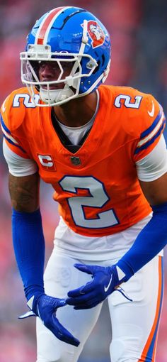 a football player wearing an orange and blue uniform