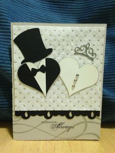 a card with two hearts and a top hat