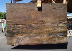 a large slab of wood sitting in the middle of a parking lot