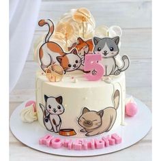 there is a cake with cats on it and the number three in front of it