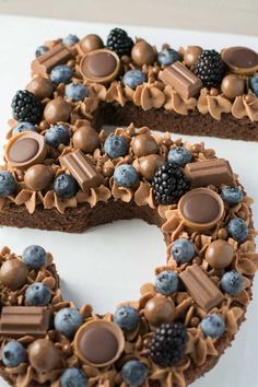 a cake shaped like the letter s is decorated with chocolate and blueberries