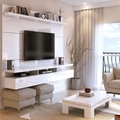 a living room with white furniture and a flat screen tv mounted to the side of a wall