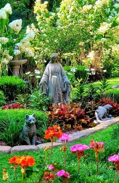 a garden filled with lots of flowers and statues