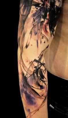 a man's arm covered in ink and watercolors with an abstract design