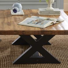 a coffee table with an open book on it