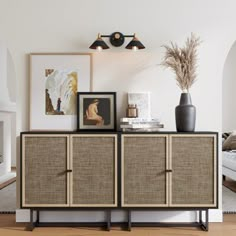 the sideboard is made out of wood and has two pictures on top of it