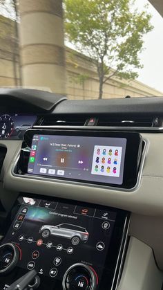 the interior of an electric car with touchscreens and steering wheel controls in motion