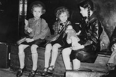 an old black and white photo of children sitting on a bench