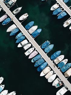 many boats are docked in the water near each other