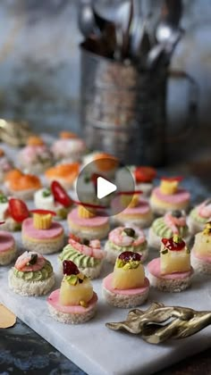 a table topped with lots of small cakes