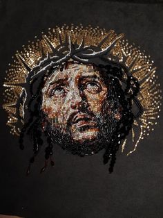 the face of jesus is made out of beads and other things that have been sequinized onto it