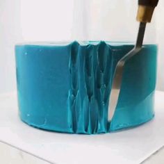 there is a blue cake with a flower on it