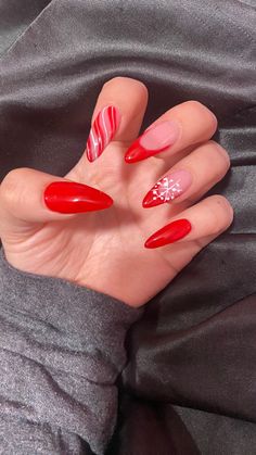 Long Oval Christmas Nails, Candy Cane Almond Nails, Candy Cane French Tip Nails Almond, Red And White Almond Shaped Nails, Almond Nails Designs Christmas, Red Glitter Swirl Nails, Candy Cane Nails Stilleto, Almond Nails Red, December Nails