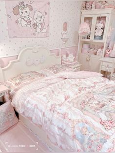 a bedroom with hello kitty wallpapers and pink bedding in the middle of it