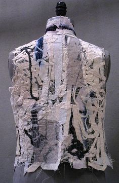 a mannequin is covered in paper and fabric