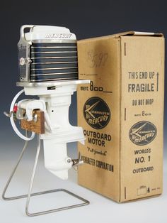 an old model motor sitting in front of a cardboard box