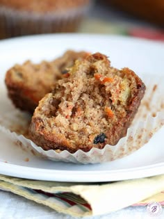 two muffins sitting on top of a white plate