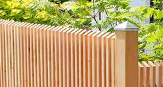 a wooden fence in front of some trees