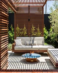 an outdoor living area with wooden slatted walls