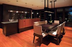 a dining room table with white chairs around it