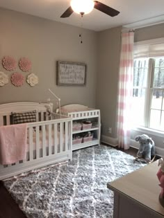 a baby's room with pink and gray decor