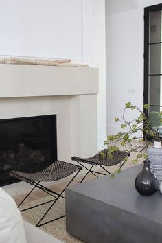 a living room with two chairs and a fire place