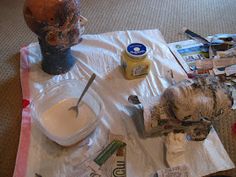 the table is covered with various items for painting