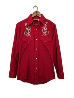 Vintage Cowboy Joe red western long sleeve shirt . It's in excellent pre-owned condition in a marked size S. Pearl snap front and sleeve hems . Treble clef at each front shoulder stitched in a sparkly metallic gray thread - 2 tone. Plastic stays in the collar for a crisp point. Chest:38 in Shoulder:17 in Sleeve:22.5 in Length:27.5 in Vintage Cowboy, Treble Clef, Shirt Men, Long Sleeve Shirt, Favorite Outfit, Sleeve Shirt, Cowboy, Art Collection, Long Sleeve Shirts