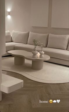 a modern living room with white furniture and wood flooring