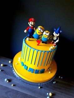 a birthday cake decorated with the characters from the movie despicables on top