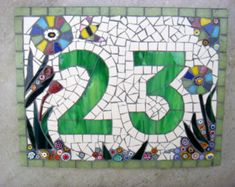 the number twenty five is made out of mosaic tiles