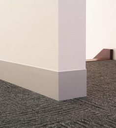 the corner of an office building with carpeting and white paint on the walls is shown