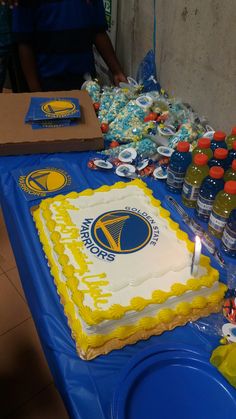 a table topped with a cake and bottles of water