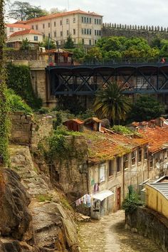 an old city with lots of buildings on top of it and a bridge above them