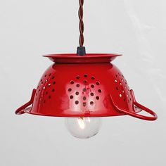 a red light hanging from a ceiling fixture