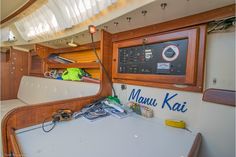 the inside of a sailboat with many items on it's table and shelves