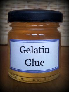 a jar of gelatin glue sitting on top of a wooden table