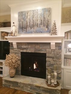 a fireplace with a painting on the mantle