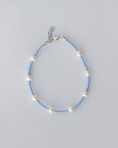 Adjustable Pearl and Blue Bead Anklet This beautiful anklet features real pearls accented by smaller blue beads, creating a fresh and summery look. Adjustable for a perfect fit, it's the ideal accessory for beach days or adding a pop of color to your everyday style. ▶ Details ◀ Length: 34 cm (+5 cm extension) Material: jewelry beads and natural pearls Fittings: rhodium Closure: Lobster claw ▶ I highly recommend adding a choker to this bracelet, which is also made of silver with a natural pearl ◀ Silver Choker: https://www.etsy.com/listing/1776877928/handmade-gemstone-beaded-necklace?click_key=e73492d2fed6b0b307f388954975368265a603fa%3A1776877928&click_sum=be037a24&ref=shop_home_active_11&pro=1&frs=1&sts=1 This bracelet will complement other pieces beautifully, creating a harmonious set.  ▶ Bead Anklet, Handmade Anklets, Beautiful Anklet, Beaded Anklet, Minimalist Women, Jewelry Dainty, Gemstone Beaded Necklace, Silver Choker, Beaded Anklets