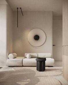 a modern living room with white furniture and circular artwork on the wall, along with round rugs