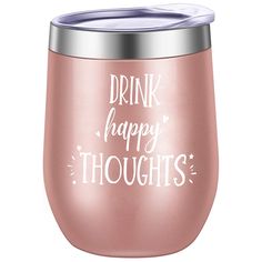 a pink wine glass with the words drink happy thoughts written in white ink on it