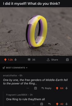 a yellow and purple ring sitting on top of a cement ground next to an email message