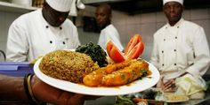 three chefs are in the kitchen preparing food on white plates with vegetables and meats