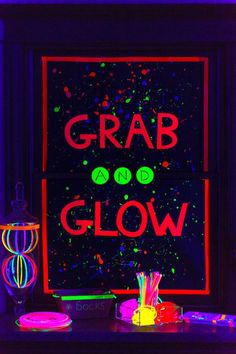 a neon sign that reads grab and glow on the side of a window in front of it