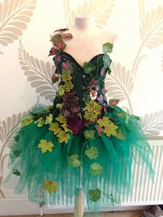 a green dress with flowers and leaves on it