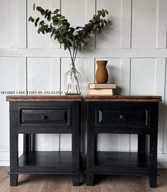 two black nightstands side by side with flowers in vase and books on the table