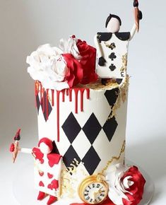 a cake decorated with red, white and black designs