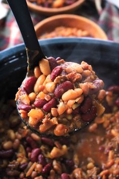 a spoon full of beans and other food