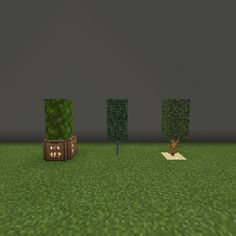 three trees in the middle of a green field