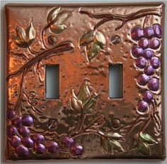 two light switch covers decorated with grapes and leaves on copper foiled metal plated